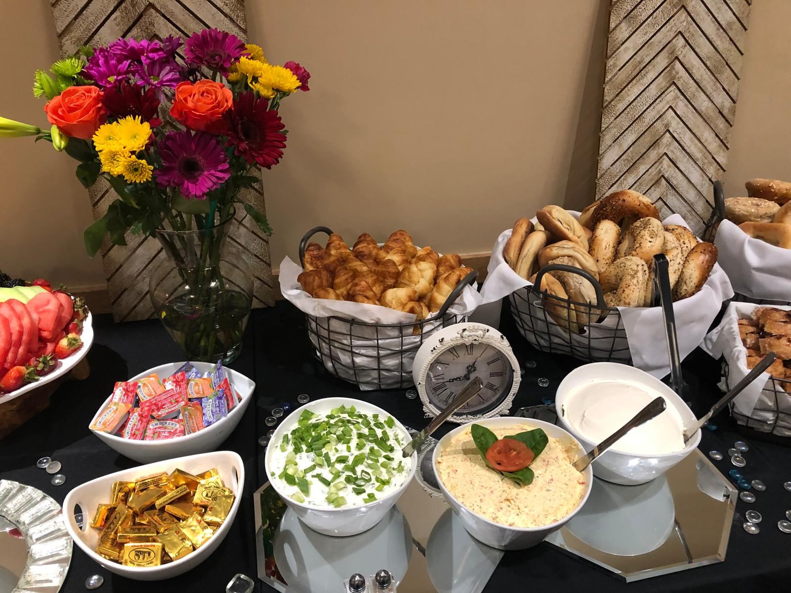 Brunch spread with croissants, bagels and fresh flowers