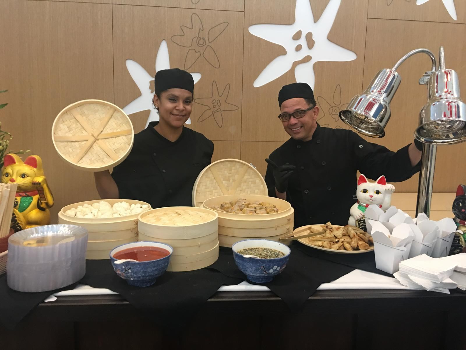 Chefs presenting bamboo steamers of dim sum