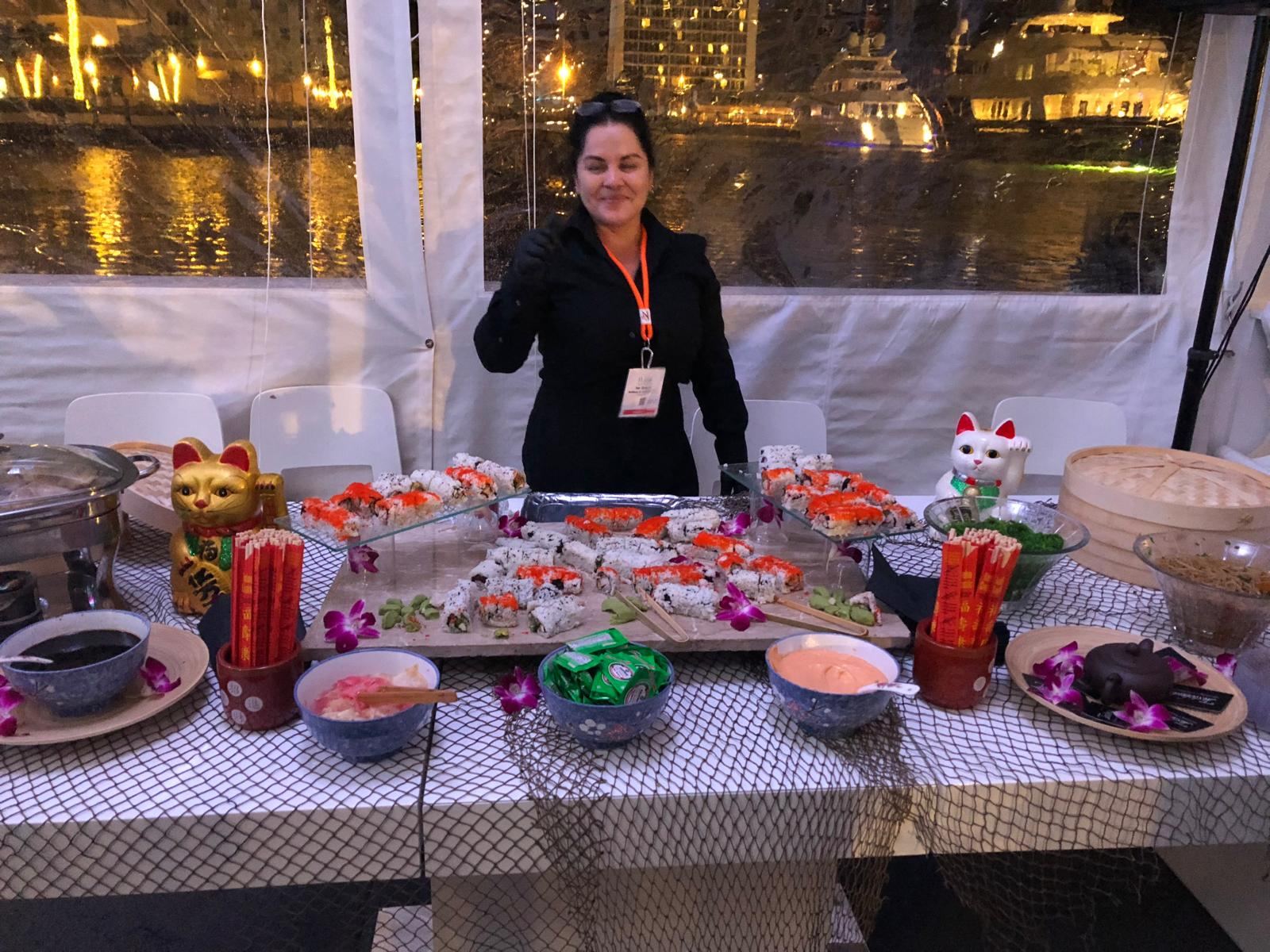 Sushi display at a waterfront evening event